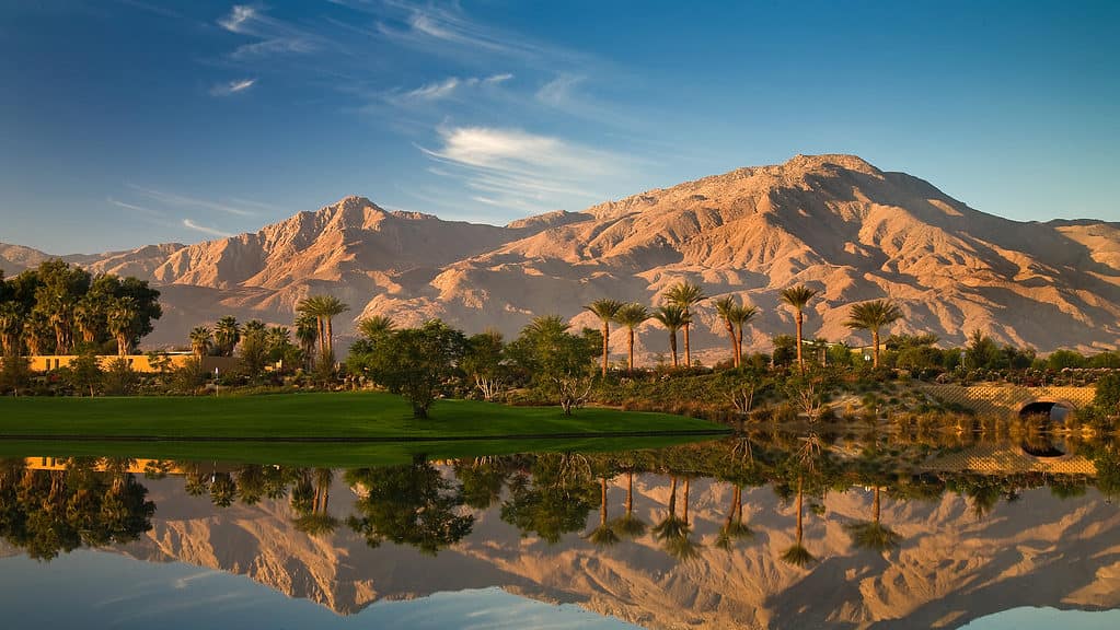 mountains reflected in mirror-like lake