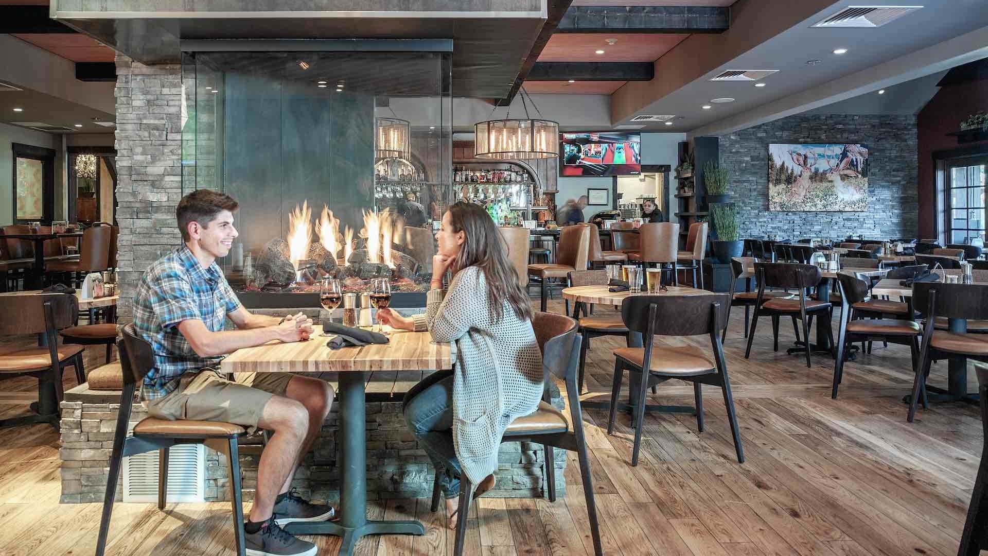 Couple sits at table in restaurant at Tenaya Lodge