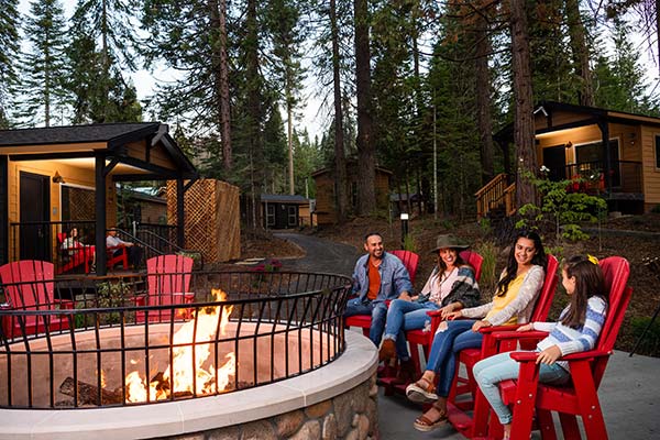 Family and dog around firepit at Tenaya Lodge in Yosemite