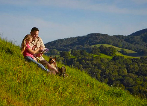 Dog and family enjoying West Hills Farm