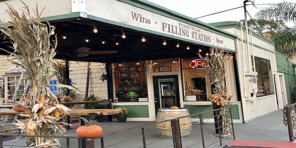a store front with a bunch of pumpkins outside of it.