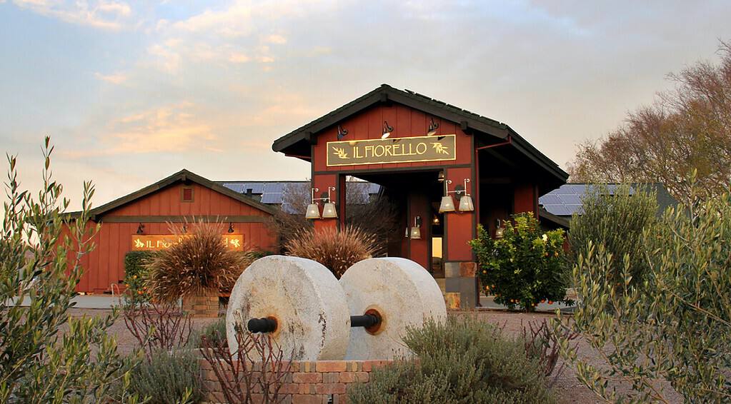 a red building with two large white wheels in front of it.