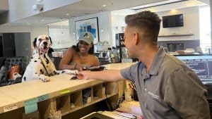 woman and dog checking into Pleasant Hill hotel