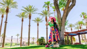 Woman and dog by palm trees in Greater Palm Springs