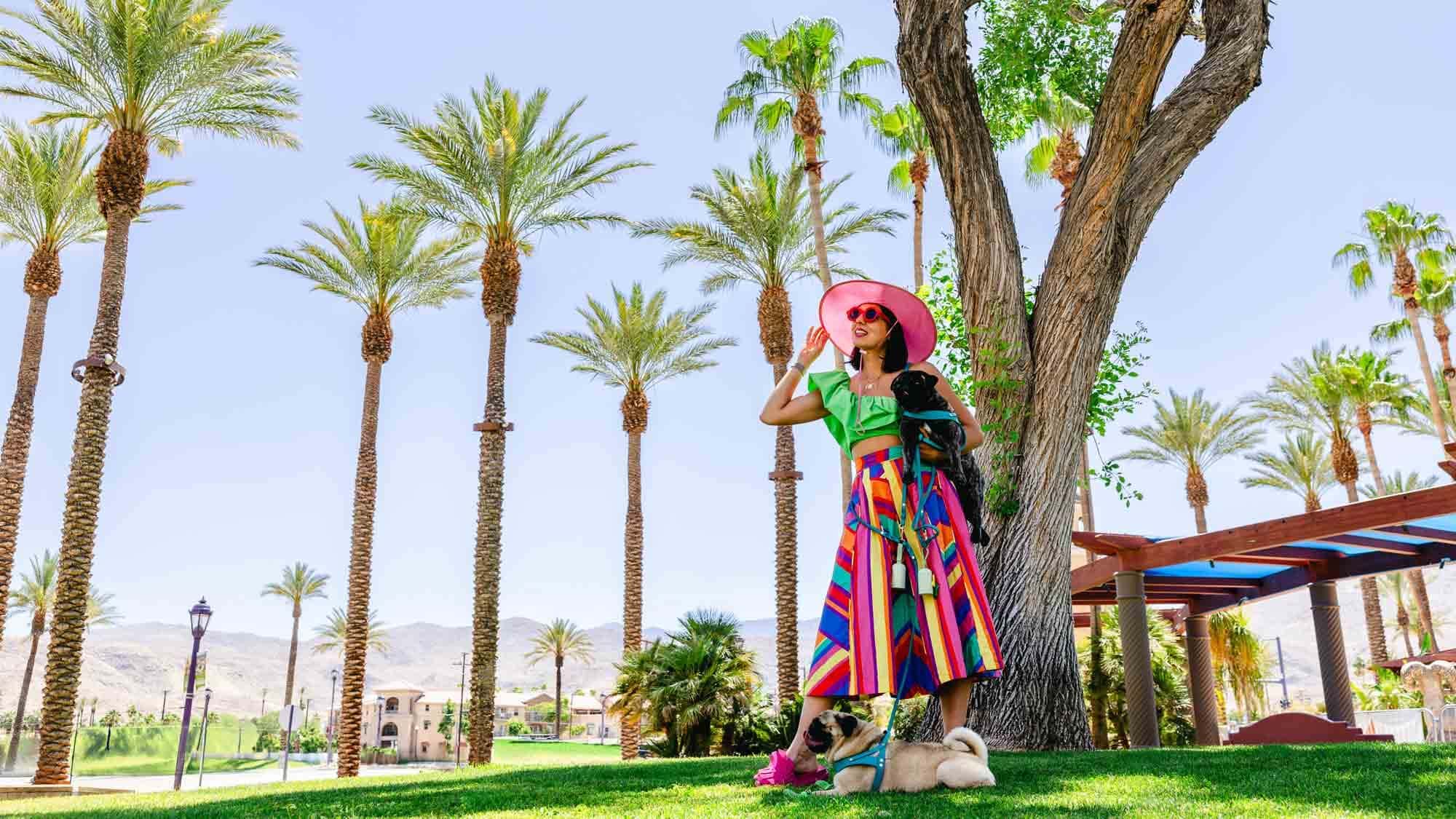 Woman and dog by palm trees in Greater Palm Springs